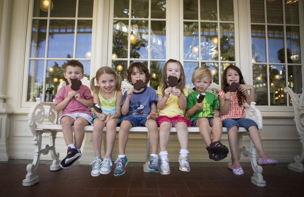 Kids eating Mickey Mouse ice cream.